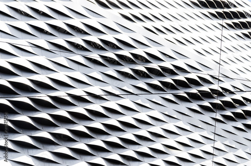 Abstract regular wavy pattern in silver steel sheet cladding