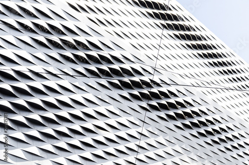 Abstract regular wavy pattern in silver steel sheet cladding photo