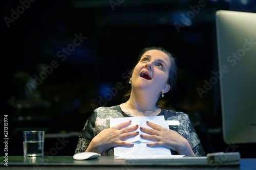 Hotel administrator. A woman-reception worker happy lady, enjoying the good news in writing. An euphoric girl is happy after reading good news in a written letter, approving a loan, raising her job. photo