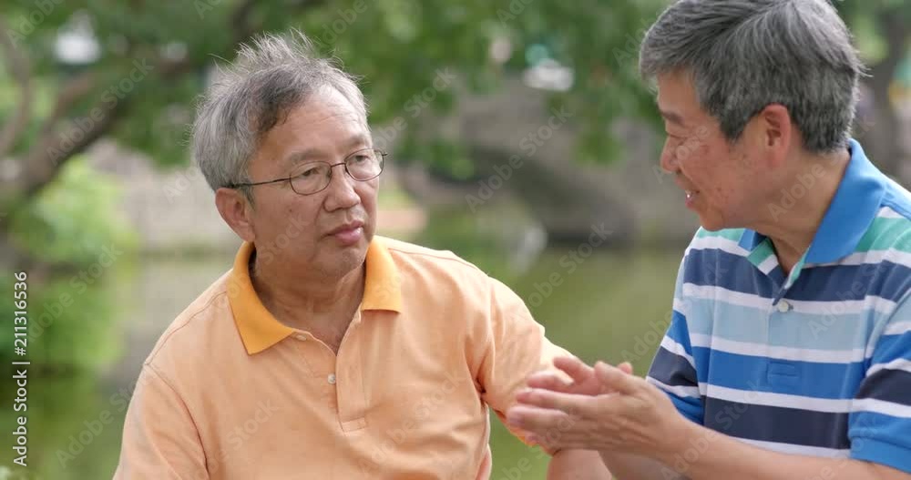 Asian Male old friends talking together at outdoor park Asian Male old friends talking together at outdoor park
