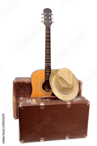 Old suitcase and guitar in country style on a white background