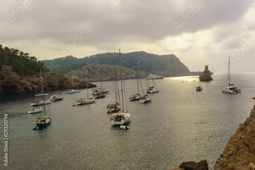 Benirras beach, Ibiza, Spain - 27 August, 2017: Benirras beach, Ibiza, Spain - 27 August, 2017: boats on the beautiful coast of Benirras in Spain photo