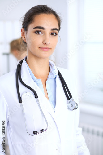 Portrait of young doctor woman in hospital. Hispanic or latin american staff in medicine