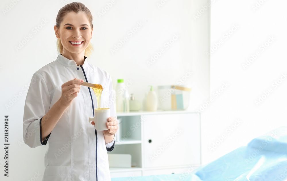 Female beautician with wax for epilation in salon Female beautician with wax for epilation in salon