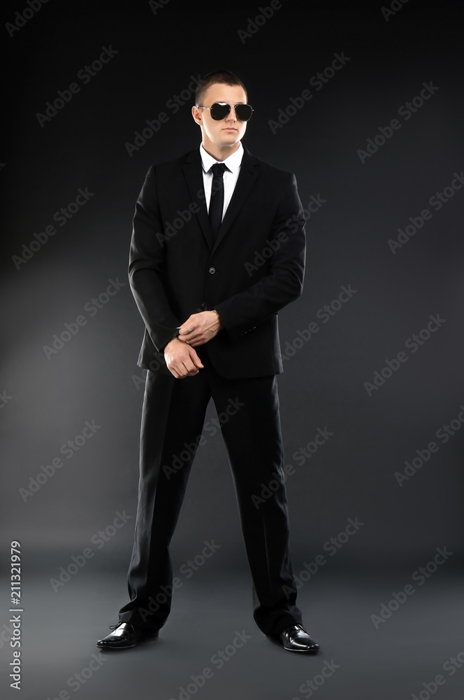 Male security guard in uniform on dark background Male security guard in uniform on dark background