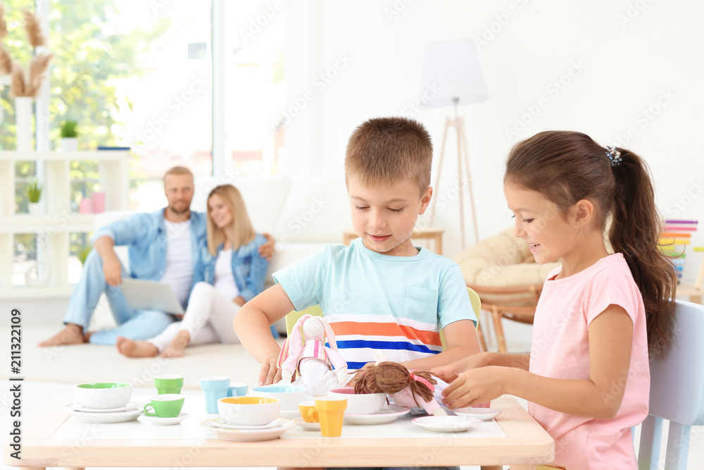 Cute little brother and sister playing at home