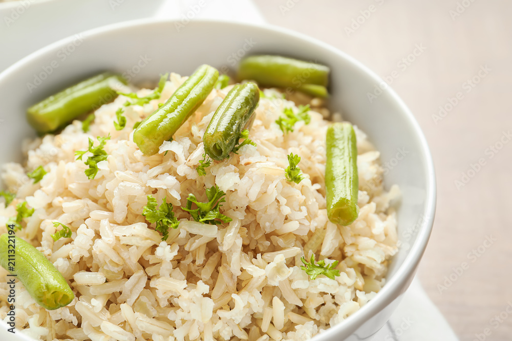 Brown rice with green beans in bowl, closeup Brown rice with green beans in bowl, closeup