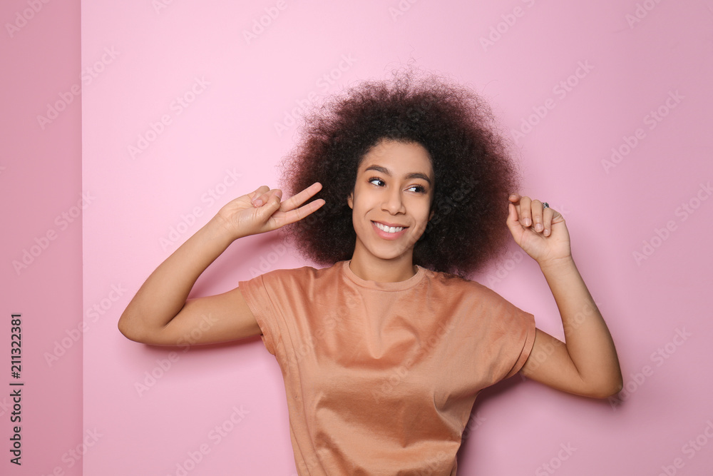 Attractive African-American woman posing on color background Attractive African-American woman posing on color background