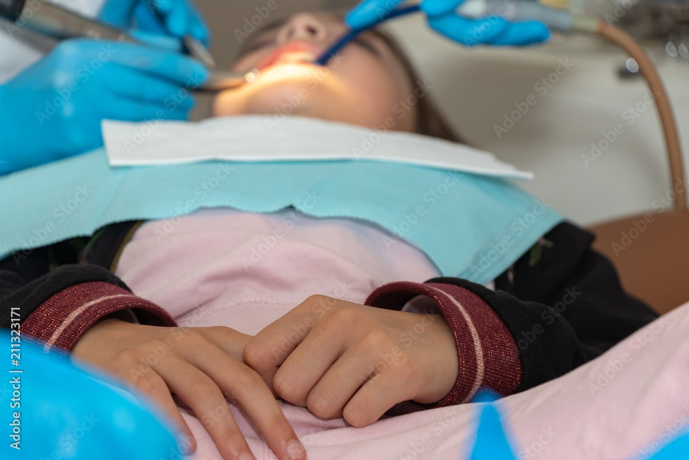 Fototapeta premium background. professional dental treatment for girls. examination and treatment by a dentist