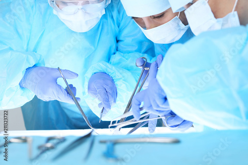 Close-up of medical team performing operation. Group of surgeons at work are busy of patient. Medicine, veterinary or healthcare and emergency in hospital