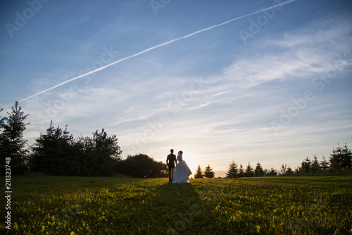 Wedding. silhouettes of the bride and groom at sunset photo