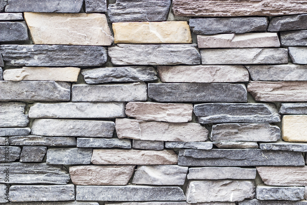 front wide shot of highlighted masonry rectangle colorful stone wall in Izmir at Turkey with traditional stucco