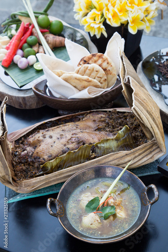 Traditional Balinese dish of steamed or roasted chicken or duck. This highly seasoned and spiced dish is a popular dish in Bali and Lombok, Indonesia. photo