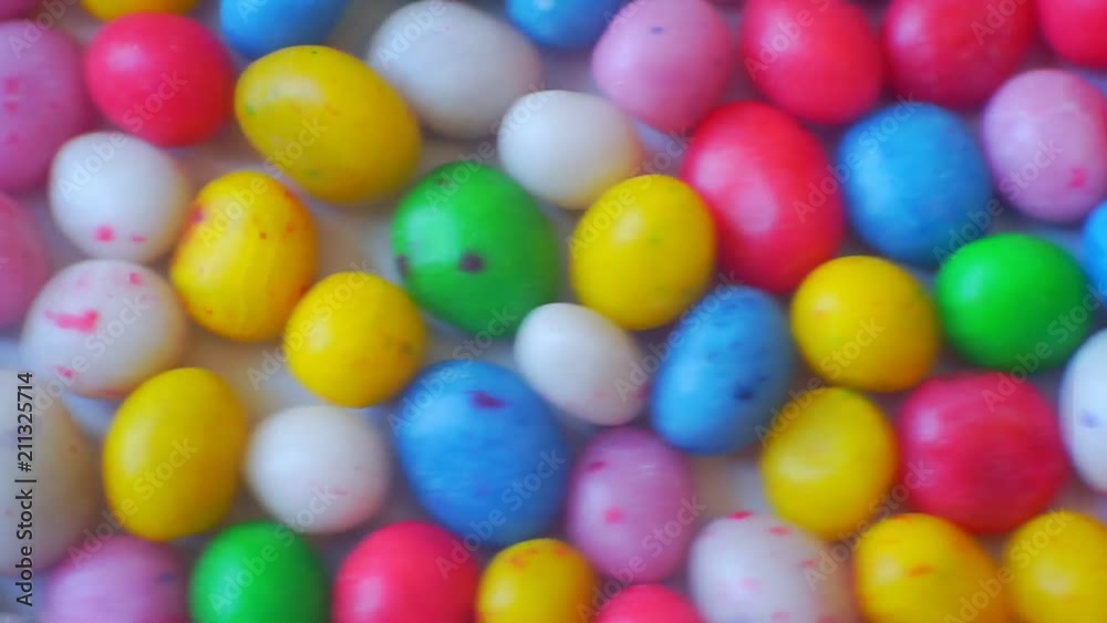 small glazed candies of different colors.closeup.abstract moving background for your design small glazed candies of different colors.closeup.abstract moving background for your design