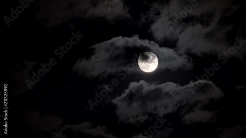 Full moon in a night cloudy sky.