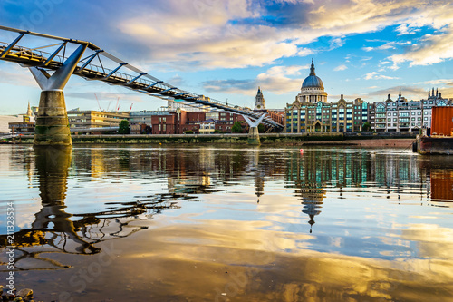 Millennium Bridge and St. Paul's cathedral at sunrise in London. England