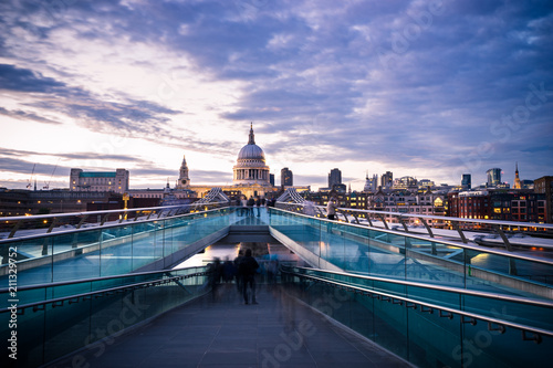 Dome of St. Paul's cathedral and Millennium Bridge at sunset