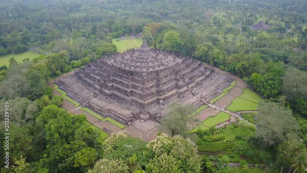 Tilting drone shot of beautiful Borobudur Buddhist temple complex, history and culture in Indonesia
