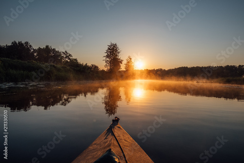 Kayaking on morning river  dawn and morning fog 