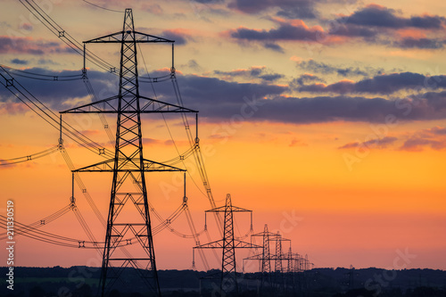 Transmission towers with colorful sunset sky