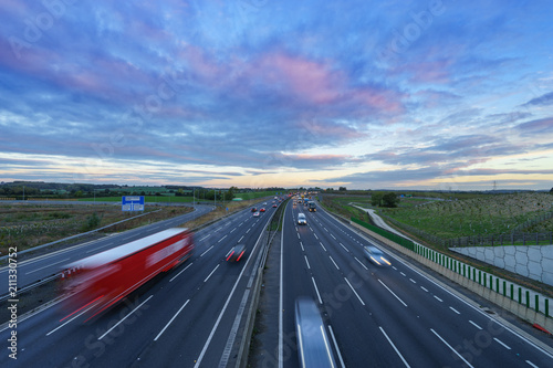 Sunrise at M1 Motorway with cars in motion