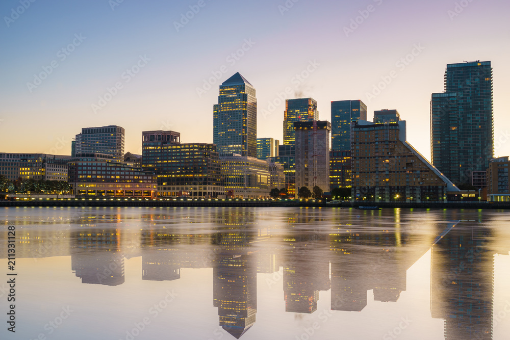 Canary Wharf business district with water reflection at sunset