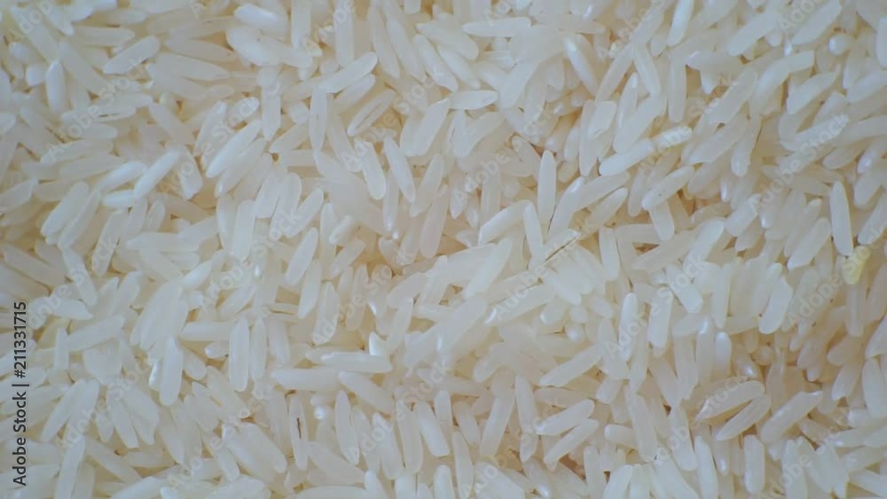 peeled ripe grain of rice.closeup.motion background. peeled ripe grain of rice.closeup.motion background.