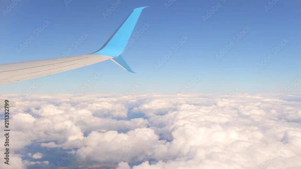 wing of an airplane and a cloud wing of an airplane and a cloud