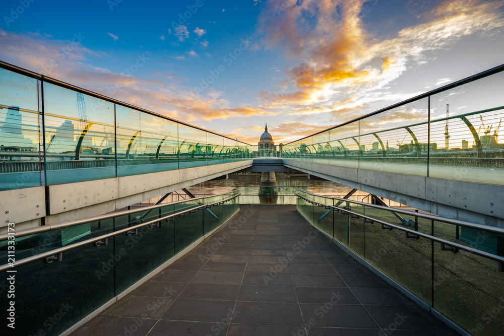 St. Paul's cathedral at sunrise in London viewed across Millennium bridge  