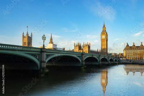 Big Ben and Westminster parliament with colorful sky and water reflection in London, United Kingdom