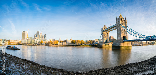 Morning panorama of London Tower Bridge and skyscrapers in financial district in London, UK
