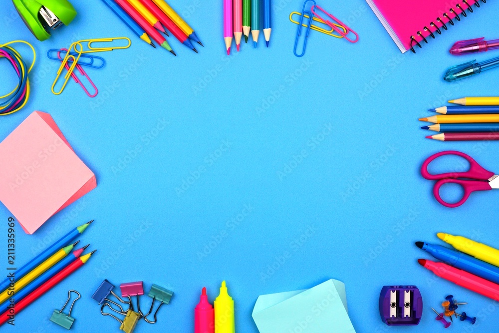 School supplies frame against a soft blue paper background School supplies frame against a soft blue paper background