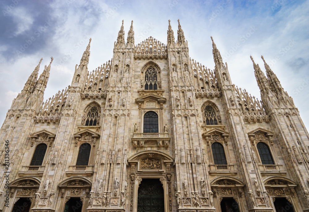 Duomo marble facade with beautiful carved stone figures. Milan, Italy
