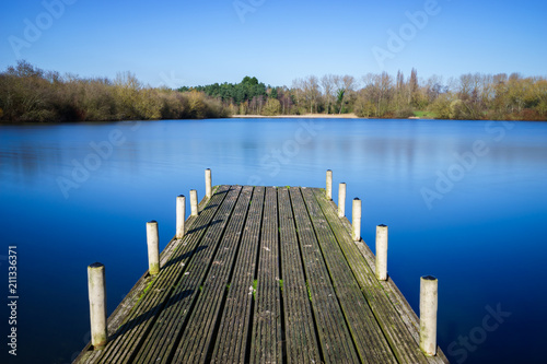 A pier at Tongwell Lake in Milton Keynes, UK photo