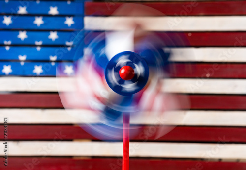 Pinwheel or whirligig in front of US flag