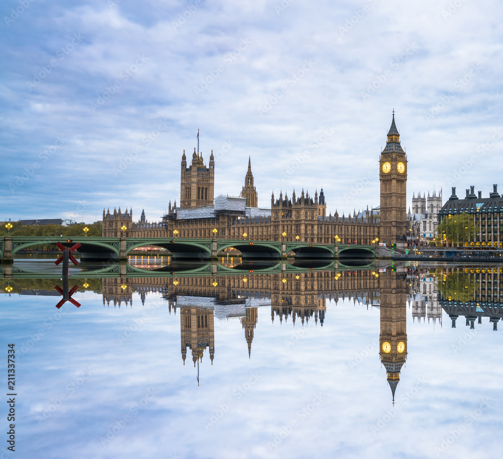 Westminster and Big Ben reflected in Thames river in London, UK
