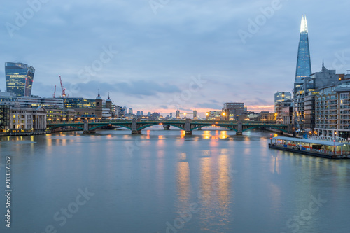 London skyline panorama including London Bridge and skyscrapers at financial district  at cloudy dawn