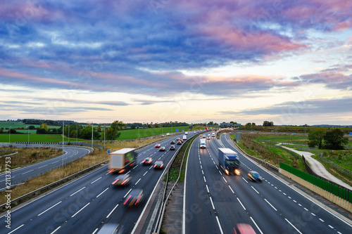 Sunrise at M1 Motorway with cars in motion