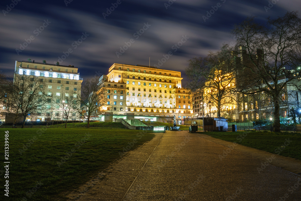 Green park station at night viewed from the pathway of Green Park near Buckingham palace