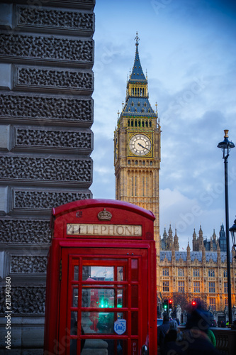 Big Ben  landmark of London at dusk with red telephone box in the foreground  selective focus