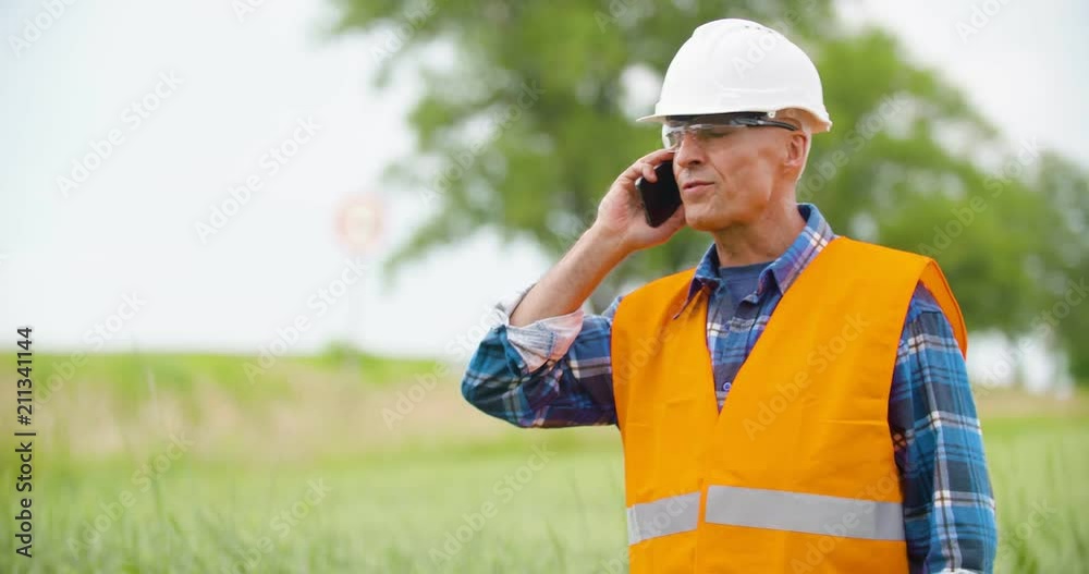 Engineer Analyzing Traffic, polution, On Clipboard Amidst Crops At Farm Engineer Analyzing Traffic, polution, On Clipboard Amidst Crops At Farm