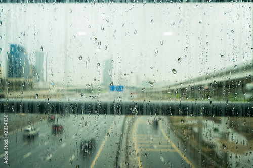 Water drops on glass window after heavy rain in Dubai, UAE photo