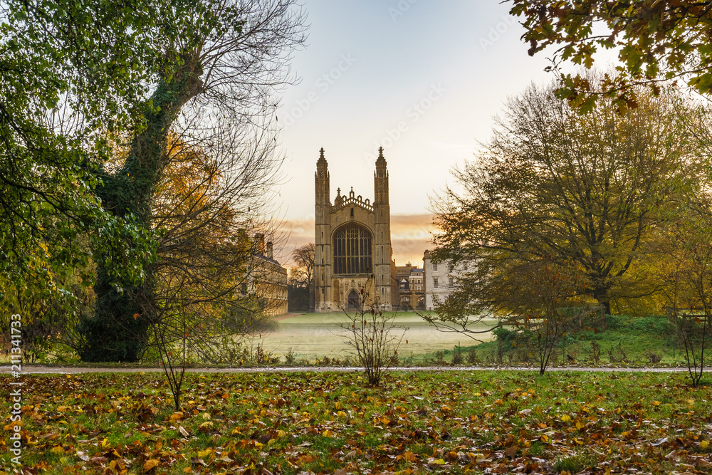 Kings College with autumn leaves at foggy morning in Cambridge,UK
