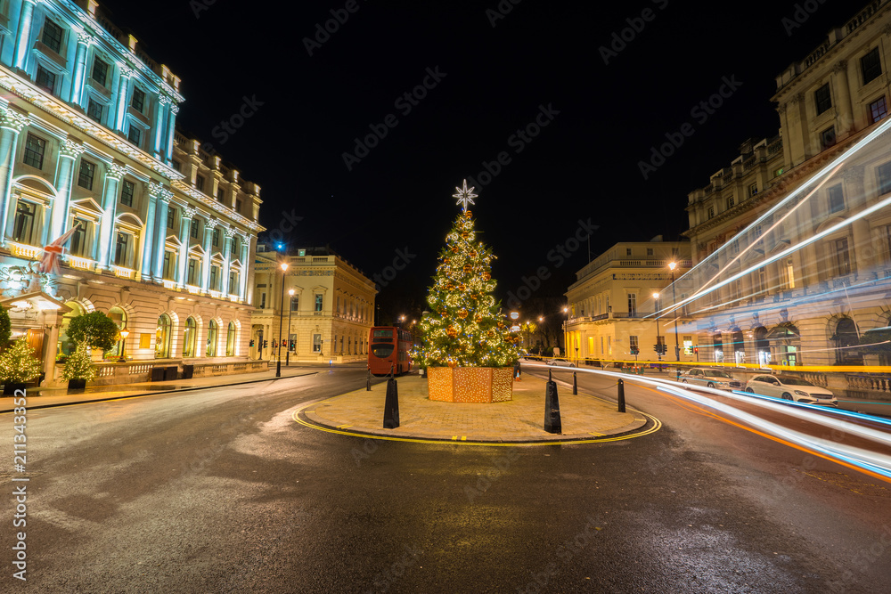 Decorated christmas tree on Waterloo place street with light trails, London, England