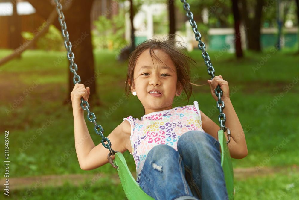 Asian girl playing on playground Asian girl playing on playground