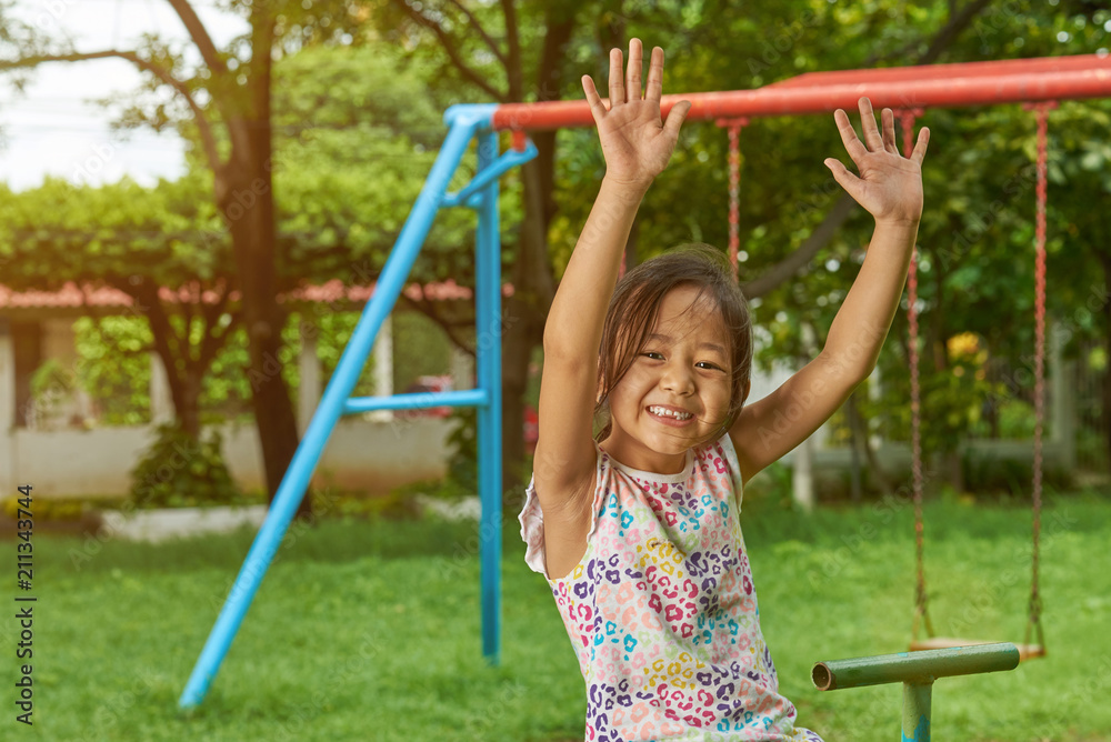 Fototapeta premium Asian girl having fun in park