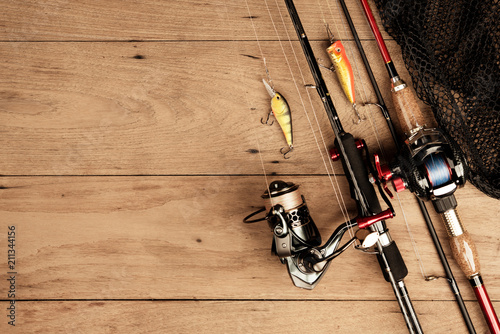 Fishing tackle on wood background on top view
