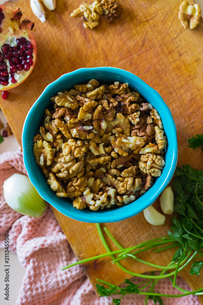 Walnuts in ceramic bowl good for salads, lunch or dinner meal and desserts. Raw vegan vegetarian healthy food. Walnuts in ceramic bowl good for salads, lunch or dinner meal and desserts. Raw vegan vegetarian healthy food.