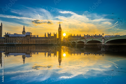 Big Ben at beautiful sunset with water reflection in London, UK