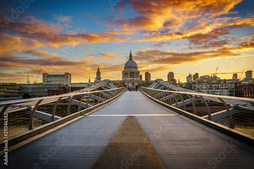 Millennium Bridge and St. Paul's cathedral at sunrise in London